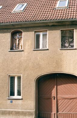 Bild: Wohnhaus mit einem Kruzifix in Wittichenau