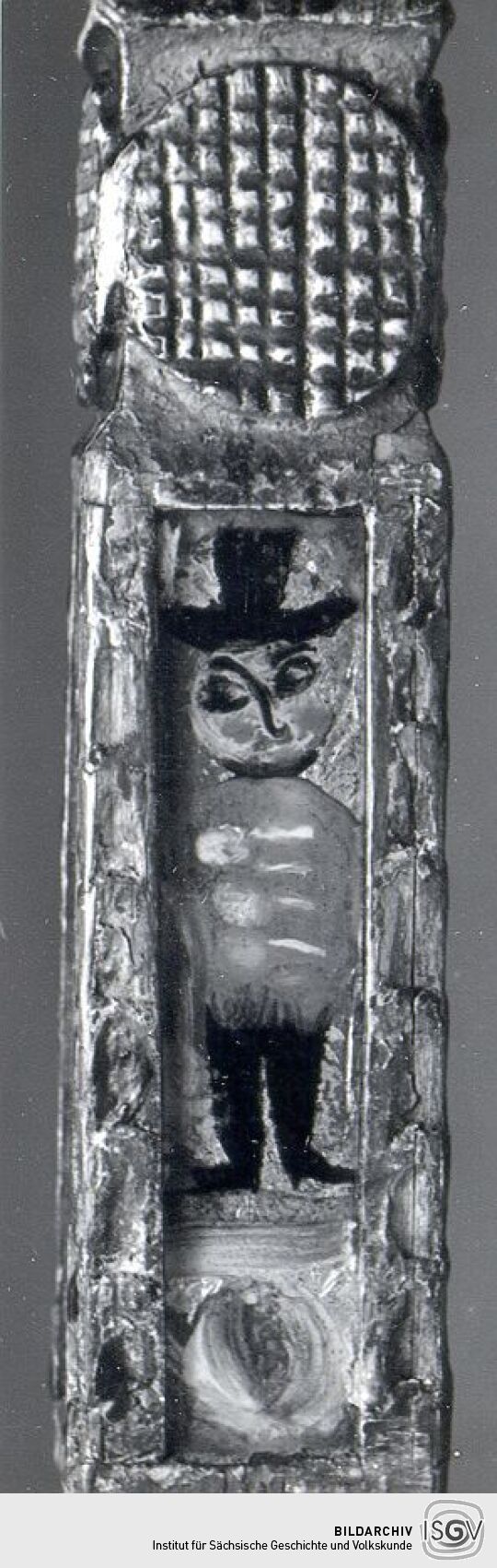 Teilstück des geschnitzten Spinnrockens