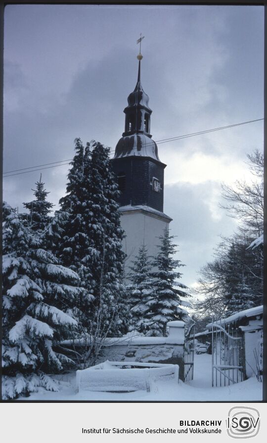 Blick zum verschneiten Kirchturm in Schellerhau