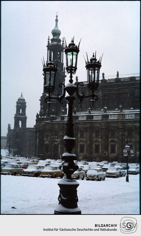 Blick auf den verschneiten Theaterplatz mit einer Laterne der Semperoper, der katholischen  Hofkirche und dem Ständehaus